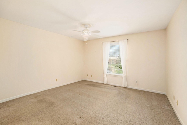 17650 Woodbridge Rd # 1, Spring Lake, MI 49456 - spare room featuring carpet floors, a ceiling fan, and baseboards