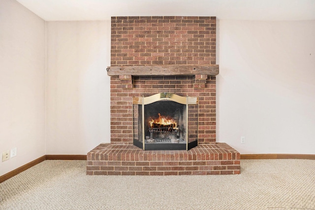 17650 Woodbridge Rd # 1, Spring Lake, MI 49456 - detailed view of carpet, baseboards, and a brick fireplace