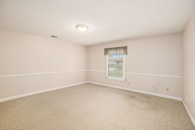 17650 Woodbridge Rd # 1, Spring Lake, MI 49456 - carpeted spare room featuring baseboards and a textured ceiling