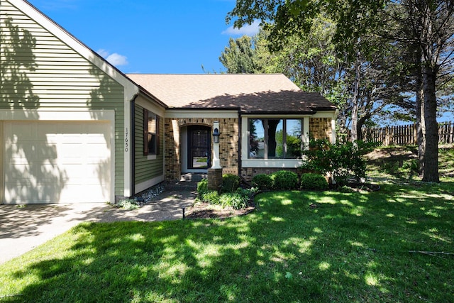 17650 Woodbridge Rd # 1, Spring Lake, MI 49456 - view of front of house featuring a garage, brick siding, driveway, and roof with shingles