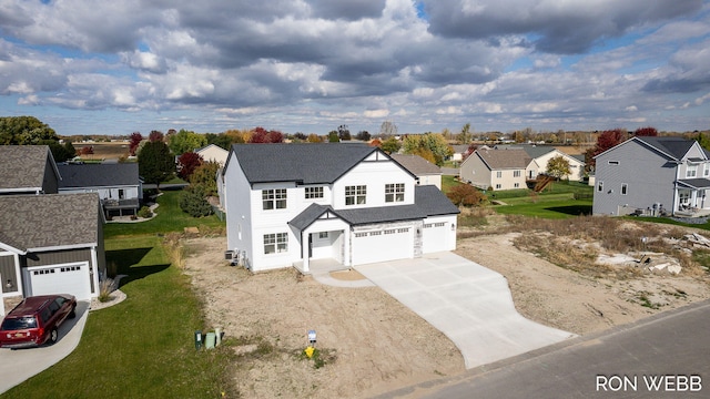 view of front of home with a front yard, concrete driveway, an attached garage, a residential view, and a shingled roof