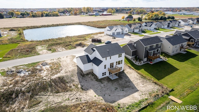 drone / aerial view with a residential view and a water view