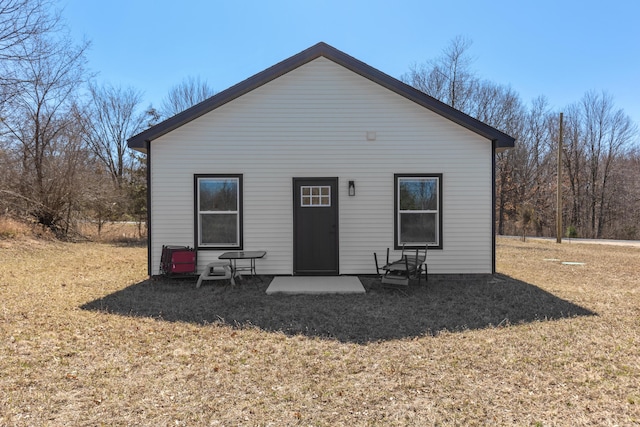 2084 W Fenwick Rd, Fenwick, MI 48834 - back of house with a patio and a lawn