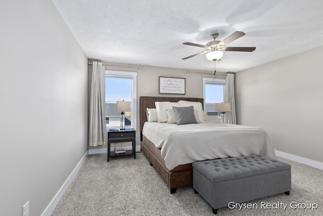 bedroom featuring multiple windows, baseboards, carpet, and a ceiling fan