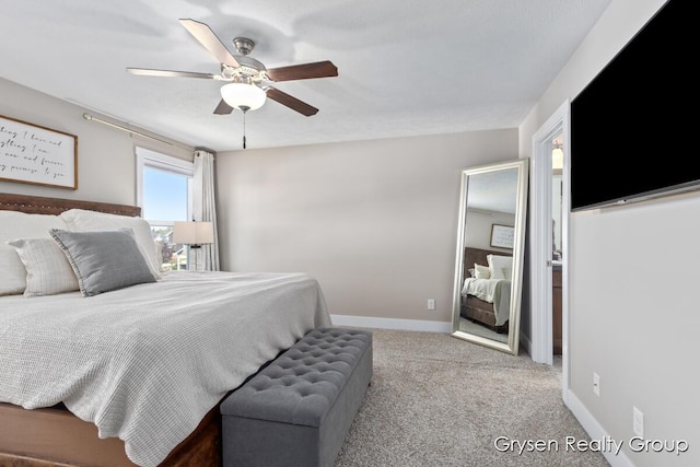 carpeted bedroom with ceiling fan and baseboards