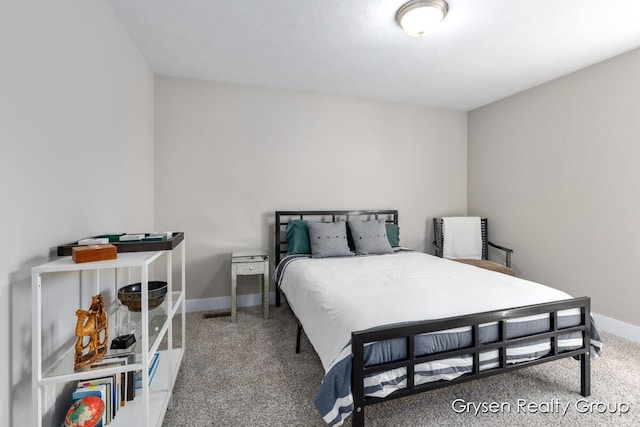 carpeted bedroom featuring baseboards