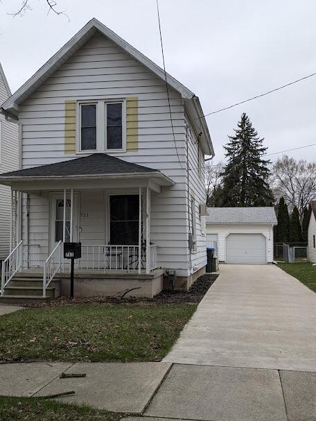 711 Randolph St, Jackson, MI 49203 - view of front facade featuring an outbuilding, covered porch, and a detached garage