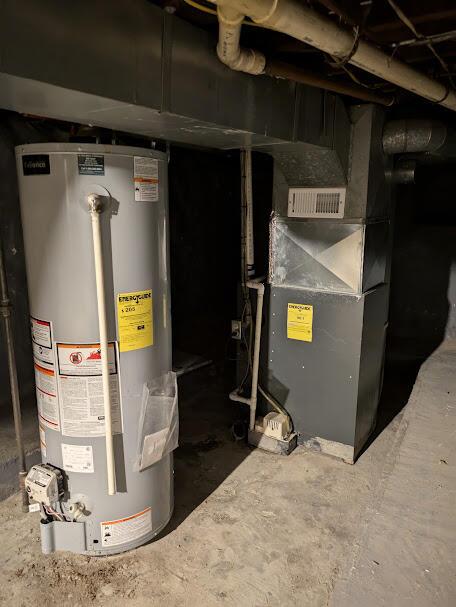 711 Randolph St, Jackson, MI 49203 - utility room featuring water heater and heating unit