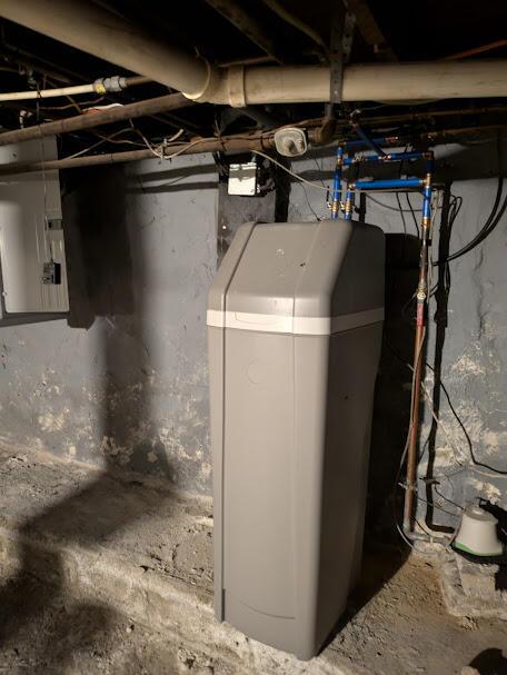 711 Randolph St, Jackson, MI 49203 - unfinished basement featuring a water softener and electric panel