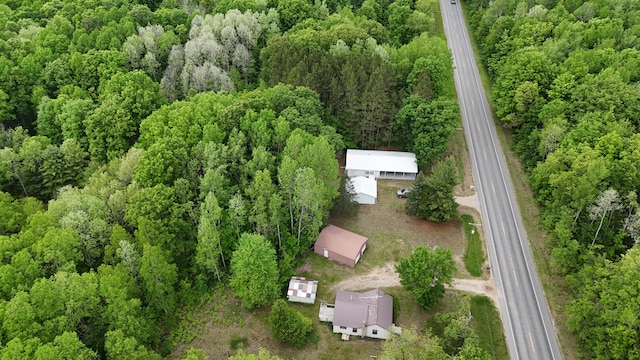 6780 N High Bridge Rd, Brethren, MI 49619 - aerial view of property and surrounding area featuring a heavily wooded area