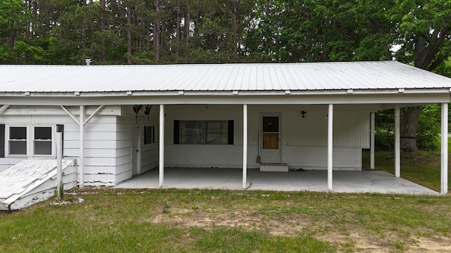 6780 N High Bridge Rd, Brethren, MI 49619 - exterior space with a yard, metal roof, and a carport