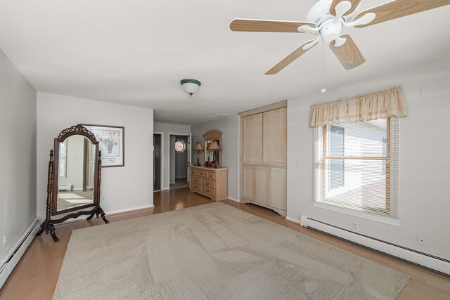 7295 Dutch Rd, Goodrich Vlg, MI 48438 - empty room with baseboards, wood finished floors, a baseboard heating unit, and a ceiling fan