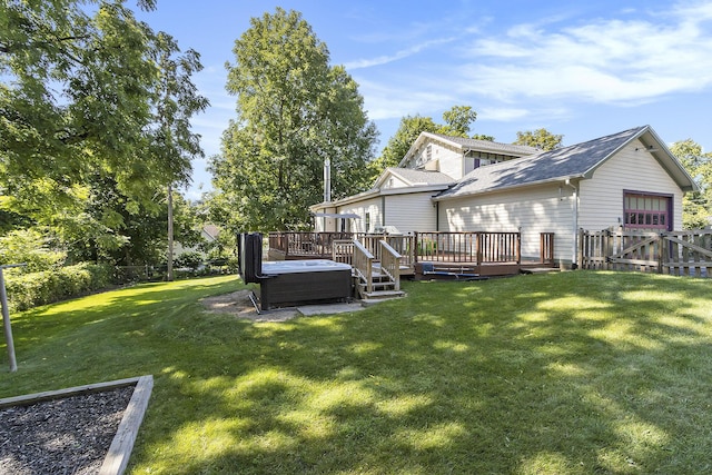 320 N Division St, Marshall, MI 49068 - back of property featuring a wooden deck, a hot tub, a yard, fence, and a shingled roof