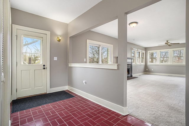 320 N Division St, Marshall, MI 49068 - carpeted foyer featuring baseboards, a ceiling fan, brick floor, and a healthy amount of sunlight