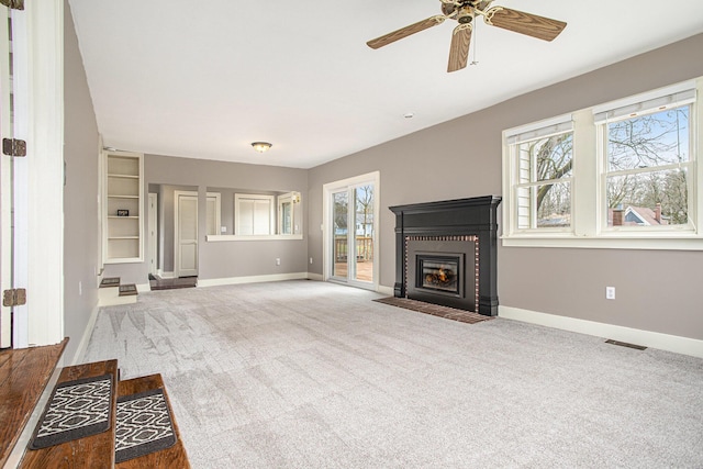 320 N Division St, Marshall, MI 49068 - unfurnished living room featuring a fireplace with flush hearth, carpet flooring, and baseboards