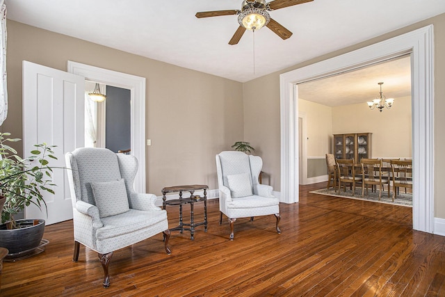 320 N Division St, Marshall, MI 49068 - living area with ceiling fan with notable chandelier, baseboards, and wood finished floors