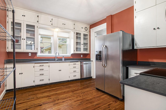 320 N Division St, Marshall, MI 49068 - kitchen featuring dark countertops, white cabinetry, a sink, and appliances with stainless steel finishes