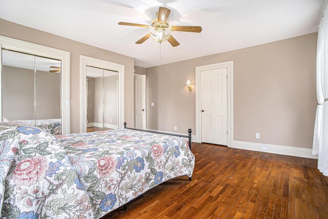 320 N Division St, Marshall, MI 49068 - bedroom featuring two closets, ceiling fan, baseboard heating, wood finished floors, and baseboards