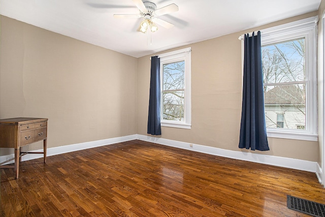 320 N Division St, Marshall, MI 49068 - unfurnished room featuring visible vents, baseboards, a ceiling fan, and dark wood-style floors