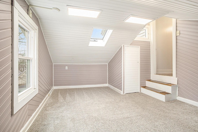 320 N Division St, Marshall, MI 49068 - bonus room featuring vaulted ceiling with skylight, baseboards, and carpet flooring