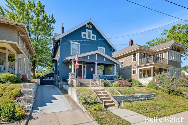 548 Pleasant St SE, Grand Rapids, MI 49503 - traditional style home featuring a porch, a chimney, and concrete driveway