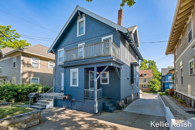 548 Pleasant St SE, Grand Rapids, MI 49503 - view of front facade with a balcony and a chimney