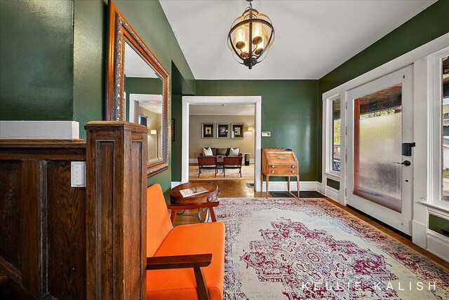 548 Pleasant St SE, Grand Rapids, MI 49503 - entrance foyer featuring wood finished floors and a chandelier