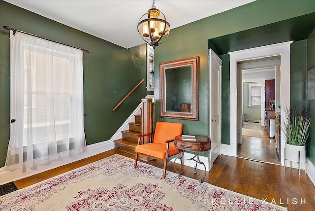 548 Pleasant St SE, Grand Rapids, MI 49503 - living area with wood finished floors, stairway, and a chandelier