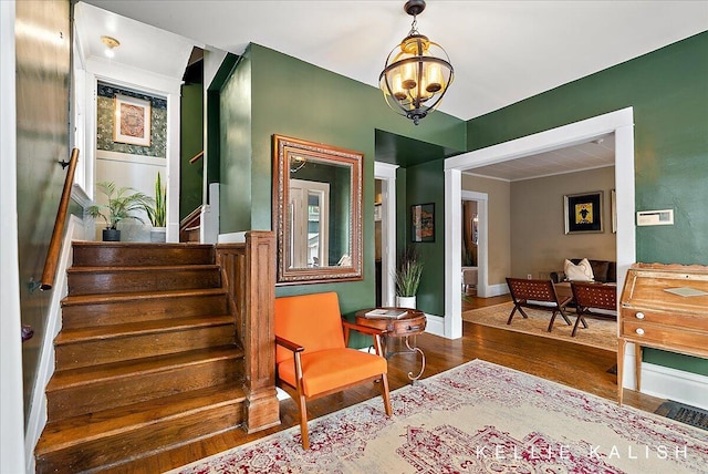 548 Pleasant St SE, Grand Rapids, MI 49503 - living area with stairs, wood finished floors, and a chandelier