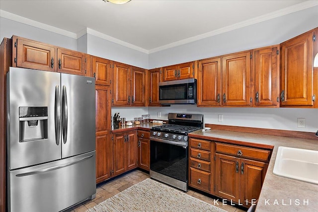 548 Pleasant St SE, Grand Rapids, MI 49503 - kitchen featuring stainless steel appliances, brown cabinets, crown molding, and light countertops
