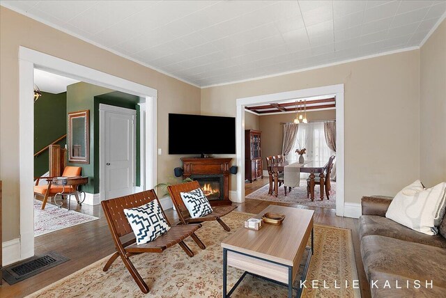 548 Pleasant St SE, Grand Rapids, MI 49503 - living area with wood finished floors, ornamental molding, and a chandelier