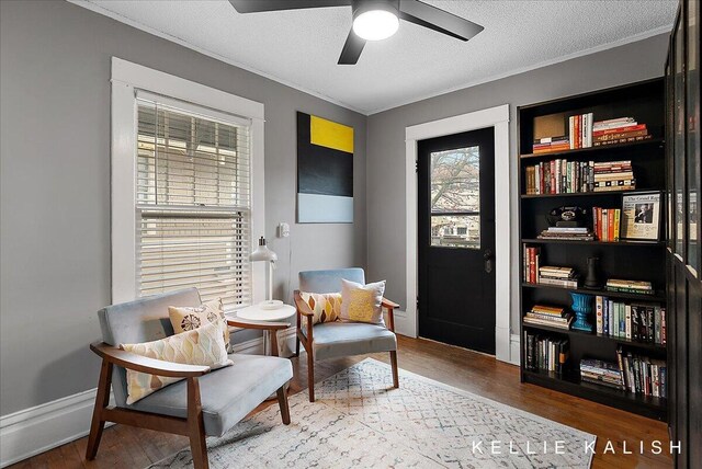 548 Pleasant St SE, Grand Rapids, MI 49503 - living area with wood finished floors, ceiling fan, a textured ceiling, and ornamental molding
