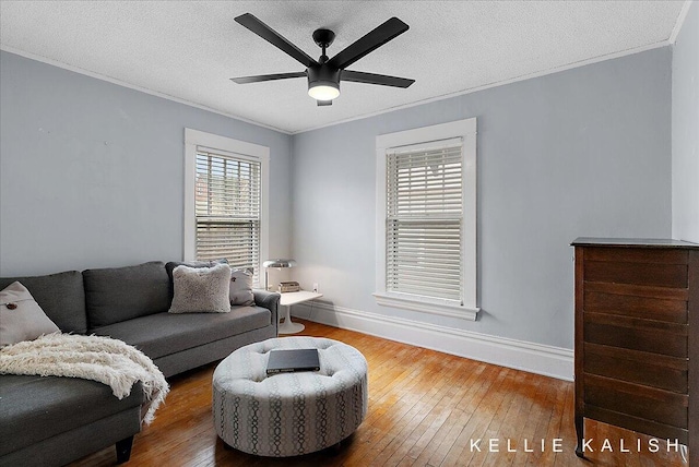 548 Pleasant St SE, Grand Rapids, MI 49503 - living area featuring ornamental molding, hardwood / wood-style flooring, ceiling fan, and a textured ceiling