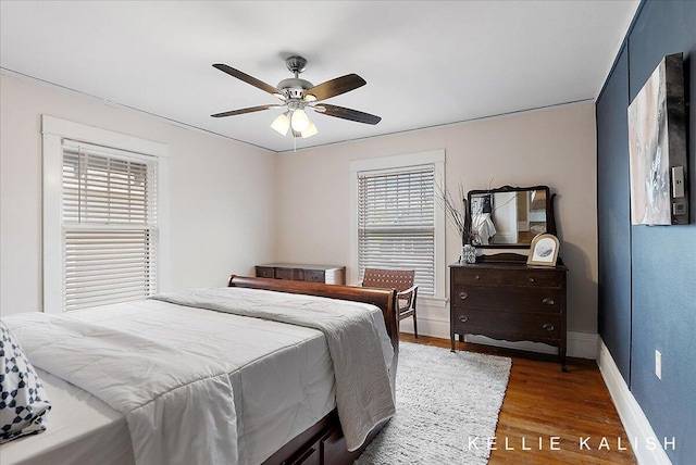 548 Pleasant St SE, Grand Rapids, MI 49503 - bedroom featuring multiple windows, wood finished floors, and a ceiling fan