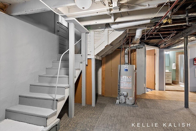 548 Pleasant St SE, Grand Rapids, MI 49503 - unfinished basement featuring water heater, stairway, and carpet