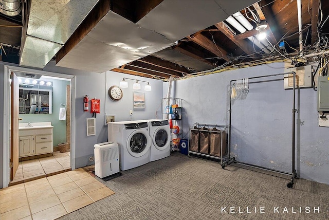 548 Pleasant St SE, Grand Rapids, MI 49503 - laundry area featuring separate washer and dryer, tile patterned floors, and electric panel