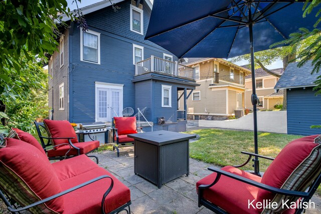 548 Pleasant St SE, Grand Rapids, MI 49503 - patio / terrace featuring a patio, french doors, outdoor lounge area, area for grilling, and a lawn