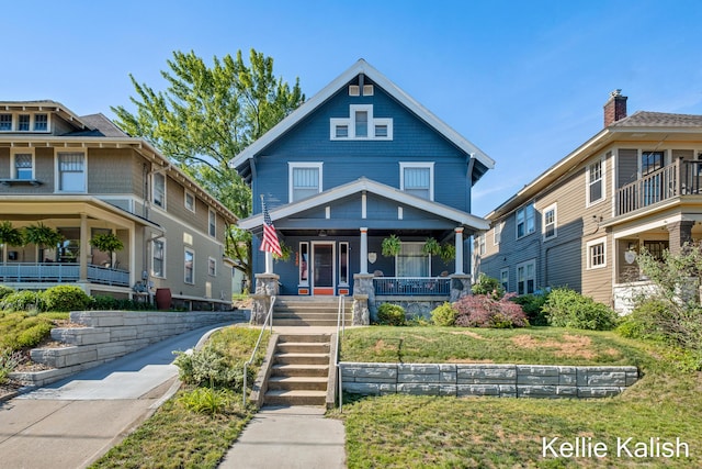 548 Pleasant St SE, Grand Rapids, MI 49503 - traditional style home with covered porch, a front lawn, and stairs