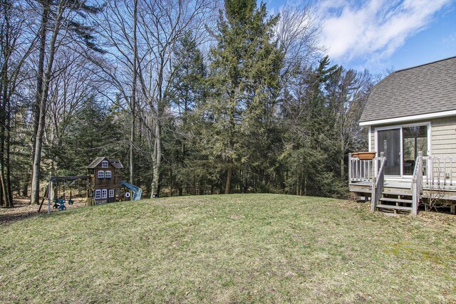 view of yard with a playground and a deck