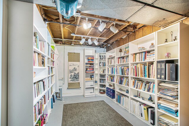interior space with concrete floors and wall of books