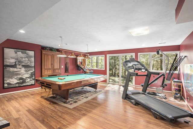 recreation room featuring billiards, a textured ceiling, and light wood finished floors
