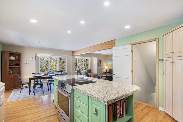 kitchen featuring open shelves, light wood finished floors, a center island, recessed lighting, and stainless steel electric range oven