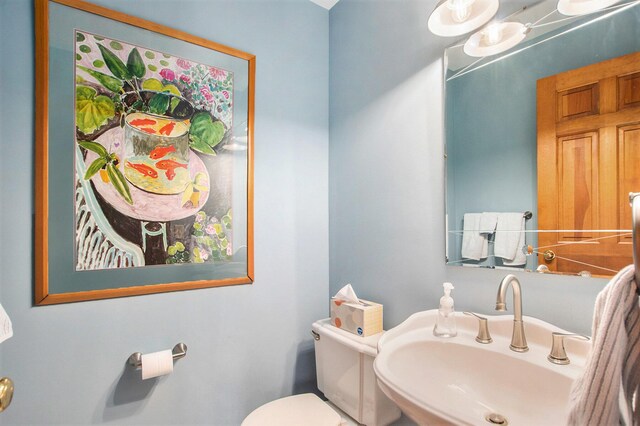 half bath featuring a sink and toilet