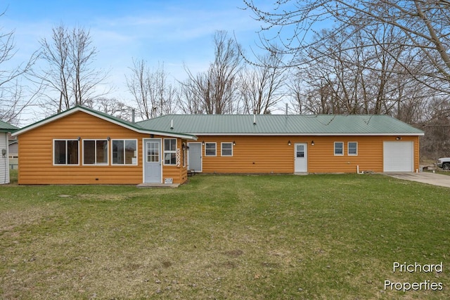 back of property with a lawn, faux log siding, a garage, and metal roof