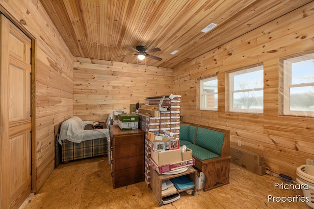 bedroom with wooden ceiling and wooden walls