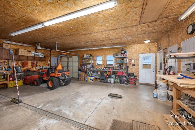 garage featuring a garage door opener and a workshop area