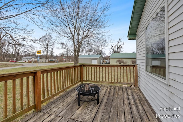 wooden deck featuring a fire pit