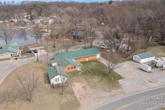 drone / aerial view featuring a water view and a residential view