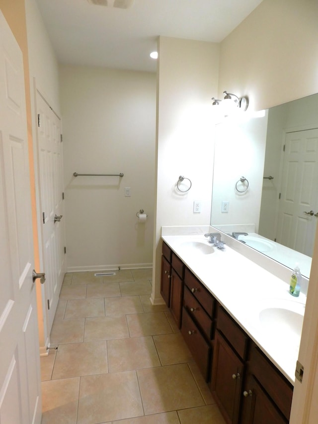 2535 Holiday House Rd Unit 24, Saint Joseph, MI 49085 - full bath featuring double vanity, tile patterned flooring, and baseboards