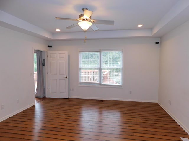 2535 Holiday House Rd Unit 24, Saint Joseph, MI 49085 - empty room featuring a raised ceiling, hardwood / wood-style flooring, ceiling fan, recessed lighting, and baseboards